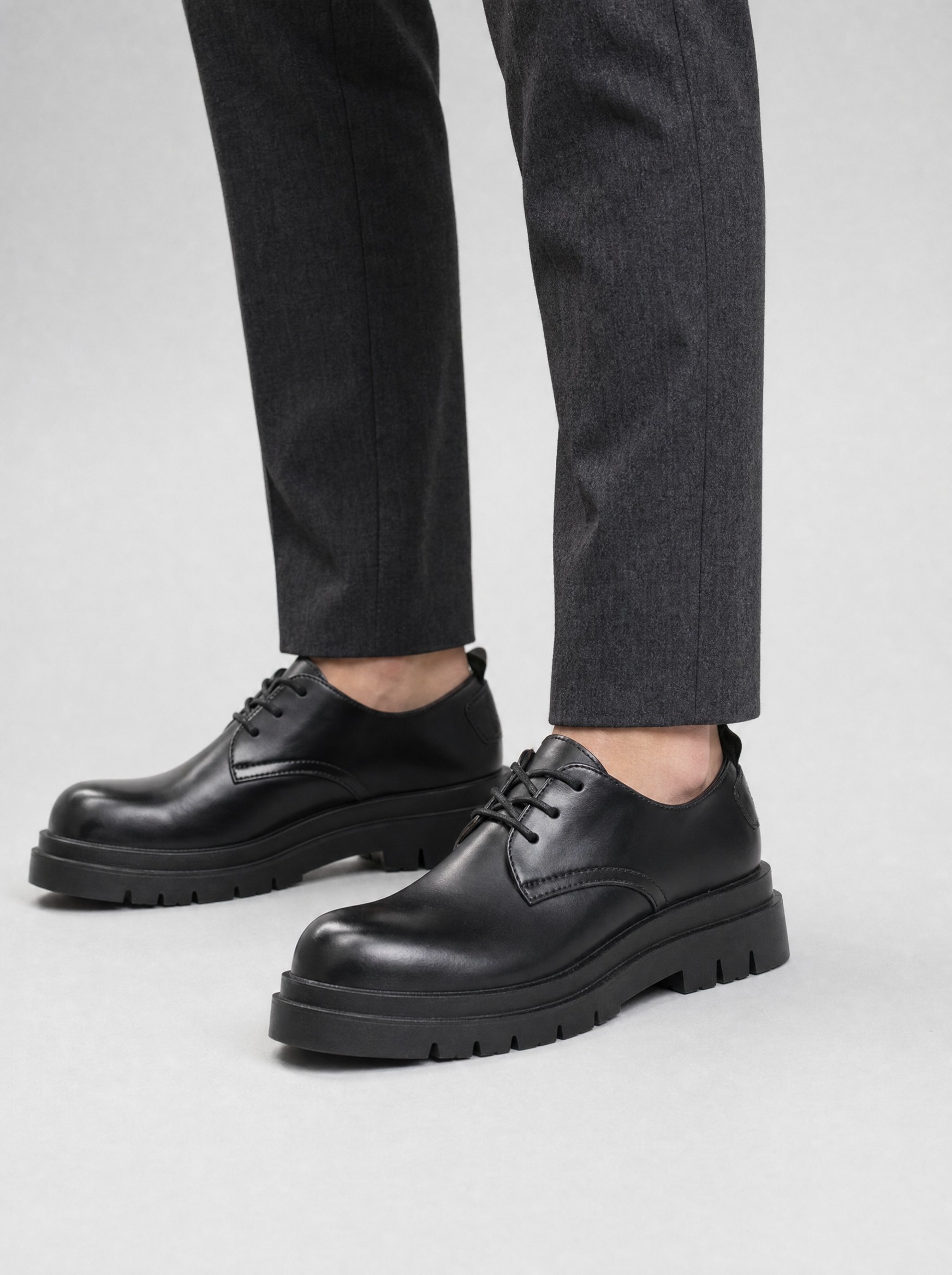 Chunky Lug Derby in polished black, AI-rendered on the house model from the product photo